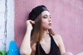 Young girl wearing cap and shorts over pink wall Royalty Free Stock Photo