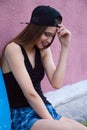 Young girl wearing cap and shorts over pink wall Royalty Free Stock Photo