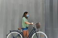 Young girl wearing a face mask holding a hipster bike Royalty Free Stock Photo