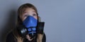 Young girl wearing gasmask, respirator portrait