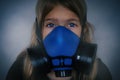 Young girl wearing gasmask, respirator portrait