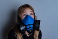 Young girl wearing gasmask, respirator portrait