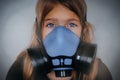 Young girl wearing gasmask, respirator portrait