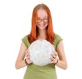 Young girl wearing glasses holding globe.