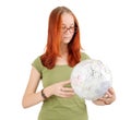 Young girl wearing glasses holding globe.