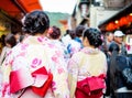 Young girl wearing Japanese kimono standing in front of japanese Royalty Free Stock Photo