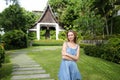 Young girl standing on green grass near resort house. Royalty Free Stock Photo