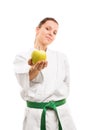 Young girl wearing kimono and offering an apple Royalty Free Stock Photo