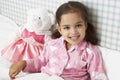 Young Girl Wearing Pajamas In Bed Reading Book Royalty Free Stock Photo