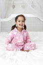 Young Girl Wearing Pajamas Sitting On Bed Royalty Free Stock Photo