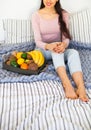 Young girl wearing pastel colored home clothes with tray full of Royalty Free Stock Photo