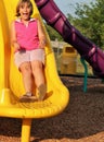 Young Girl Sliding at the Playground Royalty Free Stock Photo