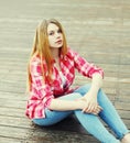 Young girl wearing a pink shirt sitting resting