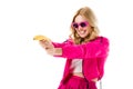 Young girl wearing pink shooting from banana