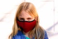 Young girl wearing protective fabric face mask.