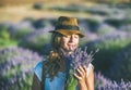 Young girl wearing straw hat with bouquet of lavender flowers Royalty Free Stock Photo