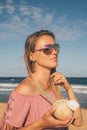 Young girl wearing sunglasses walking down the beach Royalty Free Stock Photo