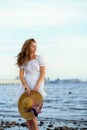 Young girl wearing white dress stay on the sea cost. Royalty Free Stock Photo