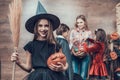 Young Girl wearing Witch Costume Holding Broom Royalty Free Stock Photo