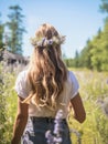 Young girl wearing a wreath of wild flowers on her head, walking in the green meadow in rural landscape. Generative AI Royalty Free Stock Photo