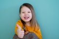 A young girl wearing a yellow shirt