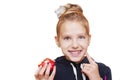 Young girl on a white background holds an red apple in her hand and smiles Royalty Free Stock Photo