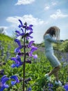 Young girl in white dress on sage field