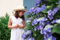 Girl staying in front of door of old stone cottage. Royalty Free Stock Photo