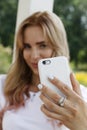 Young girl in white makes selfie