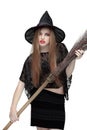 Young girl in witch costume with a broom Royalty Free Stock Photo