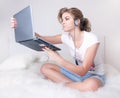 Young girl witn silver laptop and skype headset Royalty Free Stock Photo