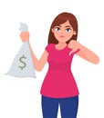 Young girl, woman or female holding/showing cash, money, currency note bag with dollar icon and gesturing or making thumb down.