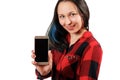 A young girl woman in a red and black shirt is holding a smartphone with a blank black screen vertically in front of her Royalty Free Stock Photo