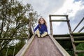 Young girl and wooden teeter board