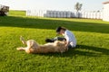 Young girl in work clothes playing with her golden retriever farm dog Royalty Free Stock Photo