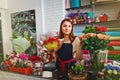 Young girl working in a flower shop Royalty Free Stock Photo