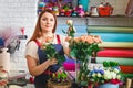 Young girl working in a flower shop, Florist woman makes a bouquet Royalty Free Stock Photo