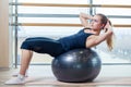 Young girl working out at the gym with a ball Royalty Free Stock Photo