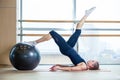 Young girl working out at the gym with a ball Royalty Free Stock Photo