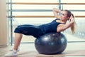 Young girl working out at the gym with a ball Royalty Free Stock Photo