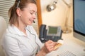 A young girl works in a call center. For a workplace with a telephone. A microphone with a microphone. Support service. Help desk Royalty Free Stock Photo