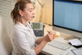 A young girl works in a call center. For a workplace with a telephone. A microphone with a microphone. Support service. Help desk Royalty Free Stock Photo