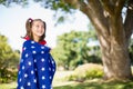 Young girl wrapped in American flag Royalty Free Stock Photo