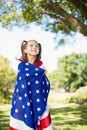 Young girl wrapped in American flag Royalty Free Stock Photo