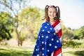 Young girl wrapped in American flag Royalty Free Stock Photo