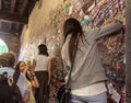 Young girl write a letter to Juliet on the wall in the passage to Juliet house in Verona, Italy Royalty Free Stock Photo