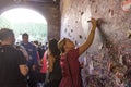 Young girl write a letter to Juliet on the wall in the passage t