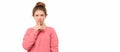 Young girl 12-14 years old keeping index finger near mouth making hush sign, say shhh. Place for your text Royalty Free Stock Photo
