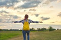 Young girl with yellow backpack, her back with open hands Royalty Free Stock Photo