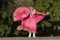 A Mexican folk dancer wearing traditional costume